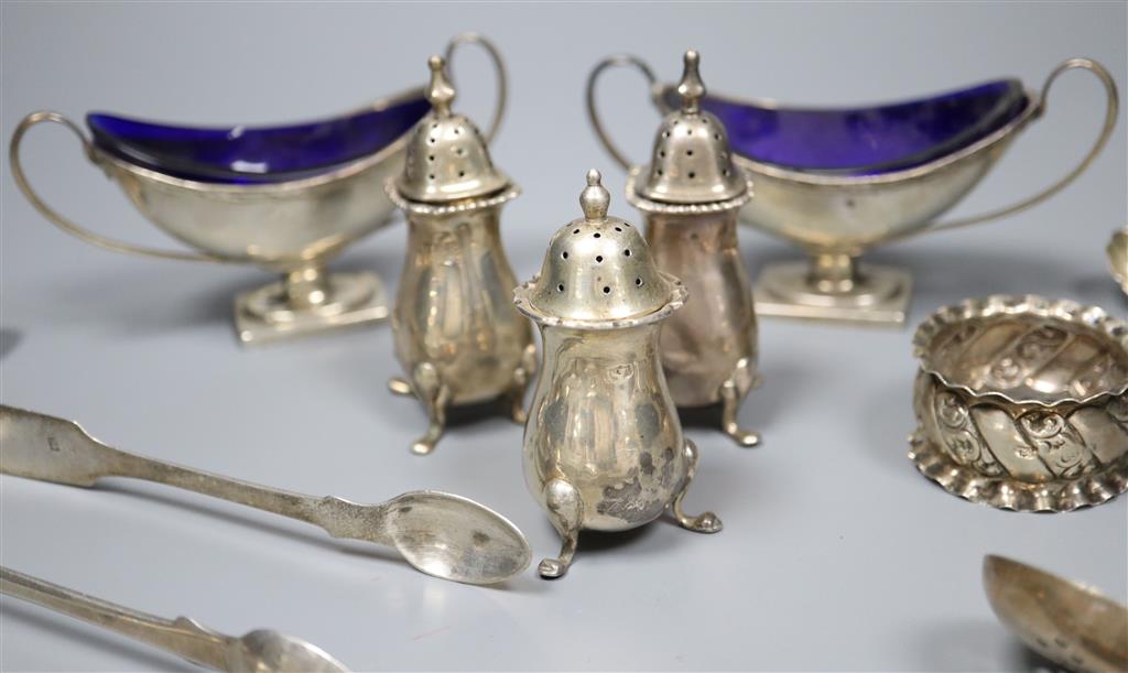 A pair of Edwardian silver boat shaped salts, three silver pepperettes and a small group of silver and plated flatware,